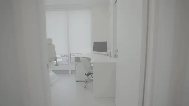 An empty, bright treatment room, filmed in a slow push-in